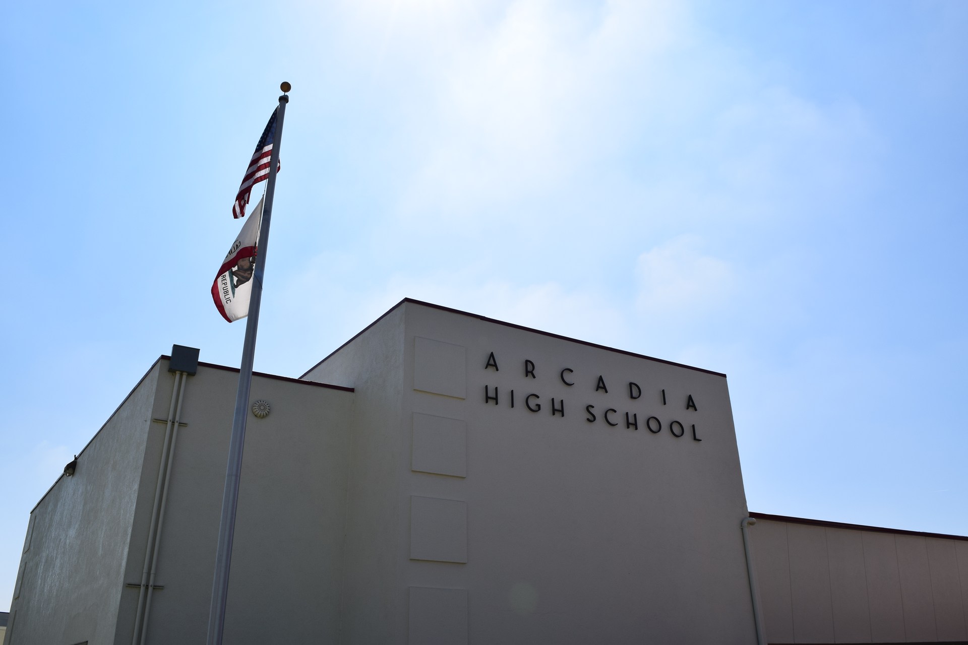 Photo of Arcadia High school building with flags